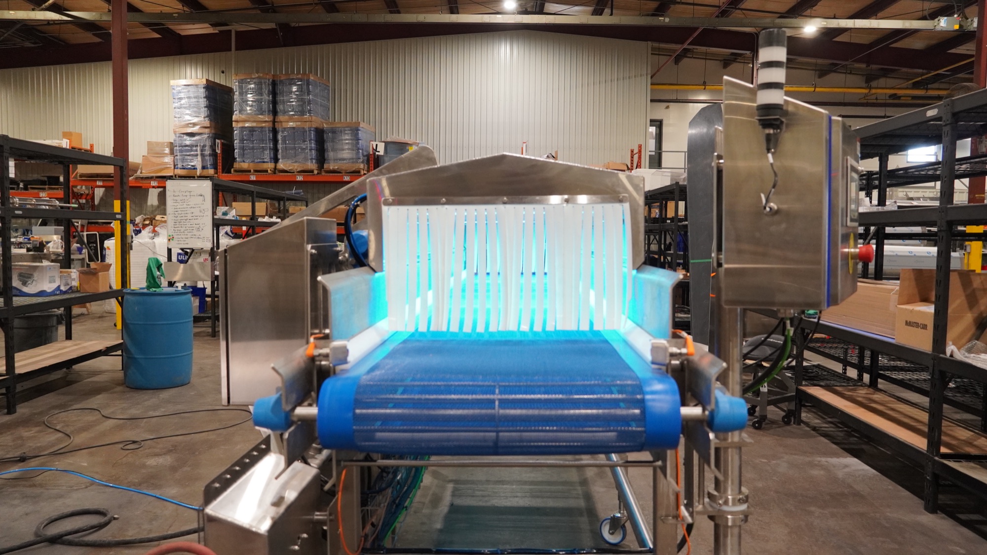 UV cleaning conveyor lit blue, controls and process integrated