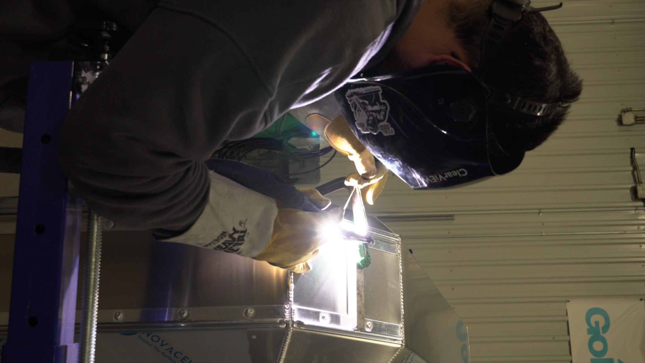 Welder fabricating a custom metal assembly